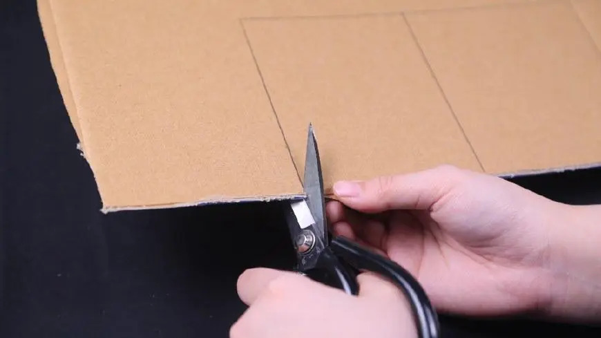 Scissors cutting cardboard